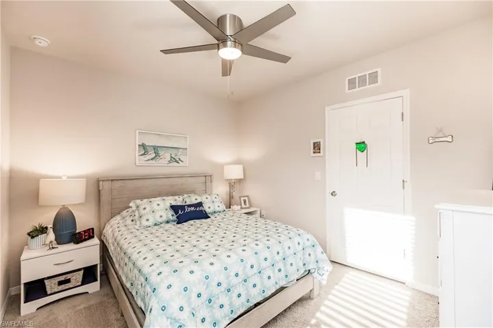 Carpeted 2nd bedroom with carpet and ceiling fan