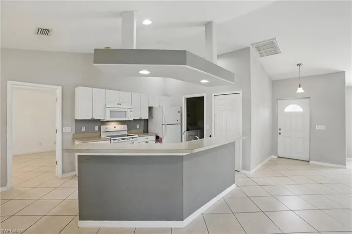 Kitchen with high vaulted ceiling