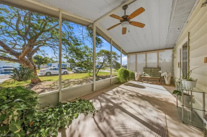 Unfurnished sunroom featuring a ceiling fan and lofted ceiling