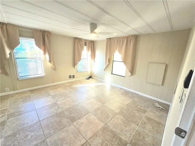 Unfurnished room featuring ceiling fan and light tile patterned floors