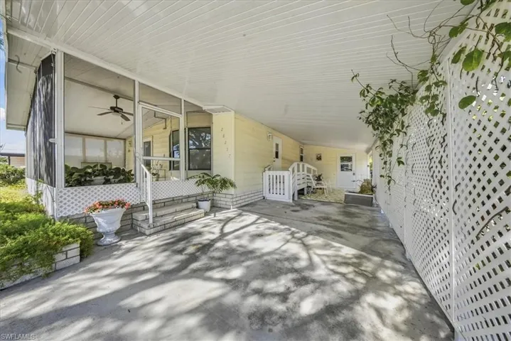 View of patio with a ceiling fan, a sunroom, and an attached carport