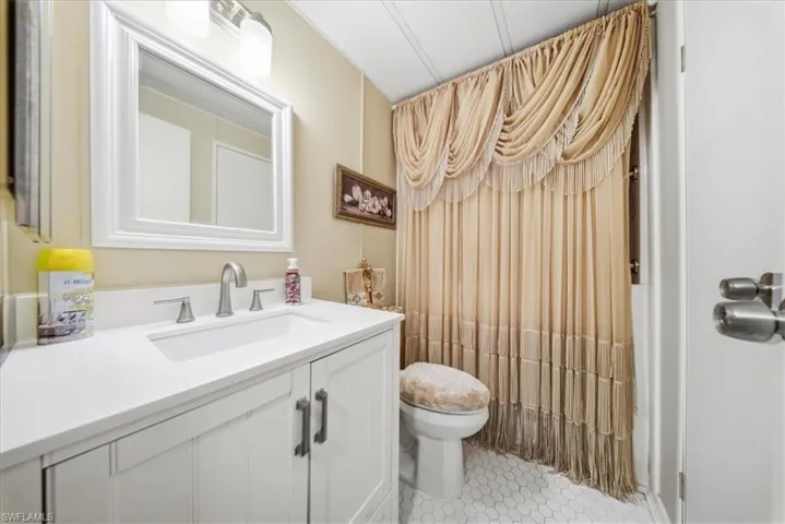 Full bathroom featuring vanity and curtained shower