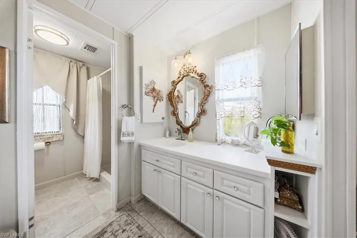 Bathroom featuring a stall shower and vanity