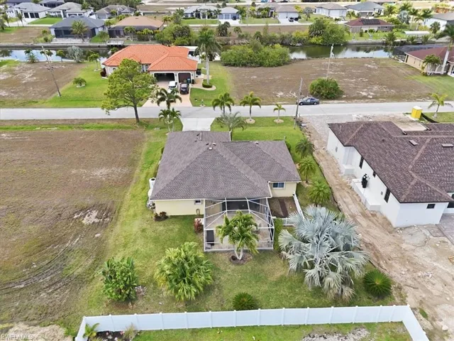 Aerial perspective of suburban area featuring a large body of water