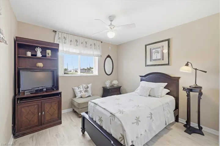 Bedroom with a ceiling fan and light wood-style floors