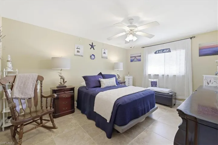Bedroom featuring a ceiling fan and light tile patterned flooring