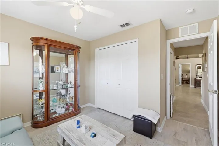 Living area featuring light wood finished floors and ceiling fan