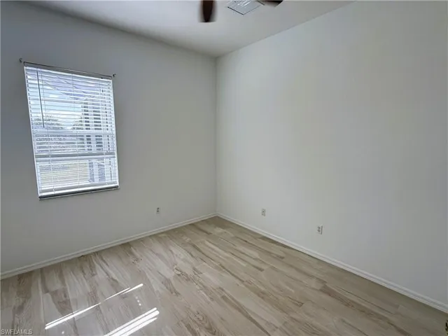 Spare room featuring light wood finished floors and baseboards