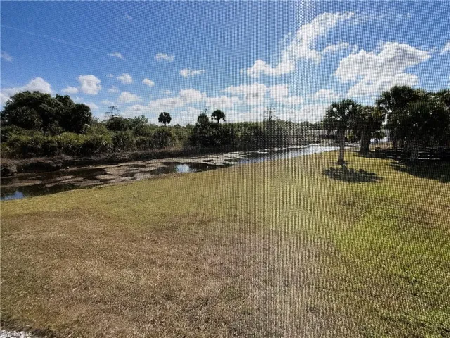 View of green lawn featuring a water view