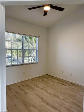 Unfurnished room featuring light wood-type flooring and ceiling fan
