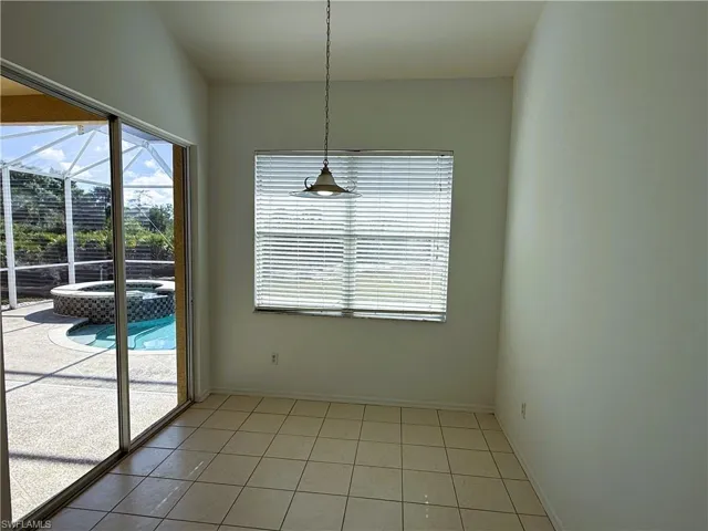 Unfurnished dining area with a sunroom, healthy amount of natural light, and light tile patterned floors
