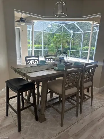 Dining area featuring a sunroom and light wood finished floors