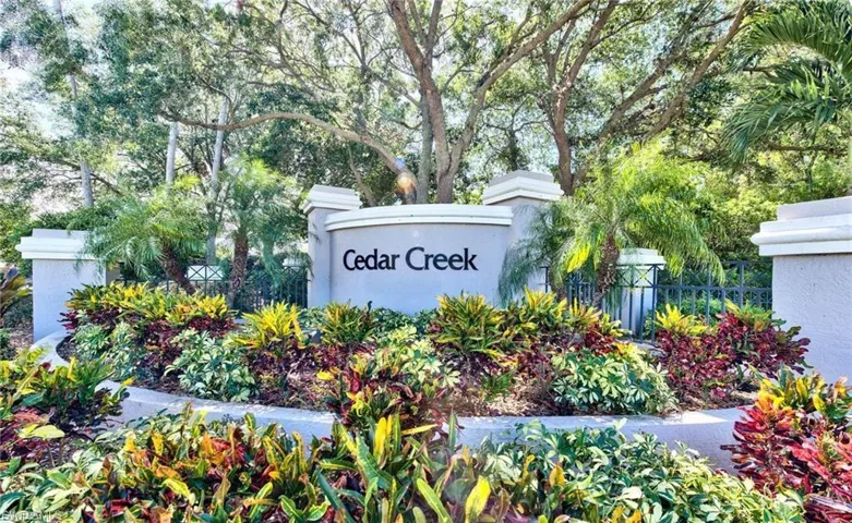 Community sign with view of wooded area