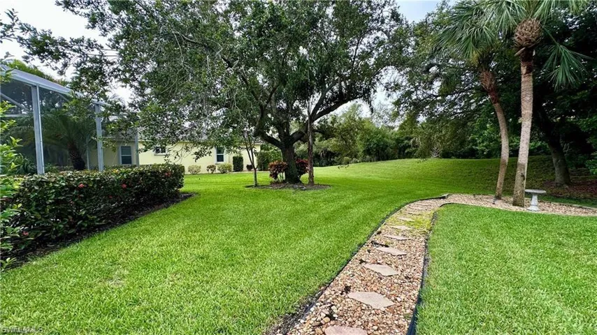 View of green lawn featuring a lanai