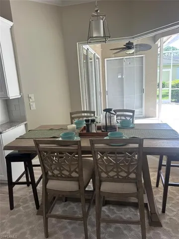 Dining area featuring ceiling fan and a sunroom