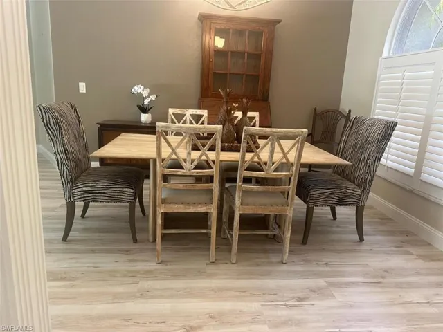 Dining room featuring light wood-type flooring and baseboards