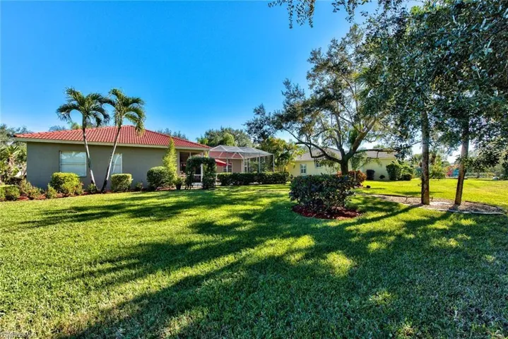 View of green lawn featuring a lanai