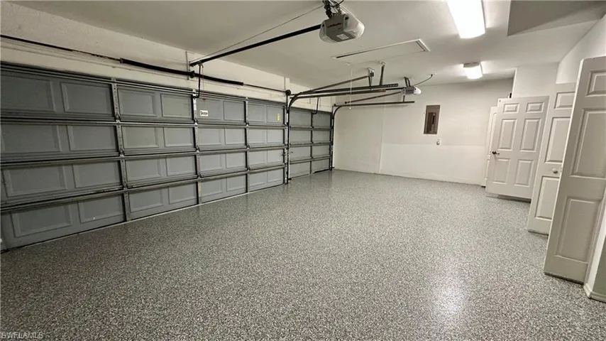 Garage with a garage door opener and electric panel