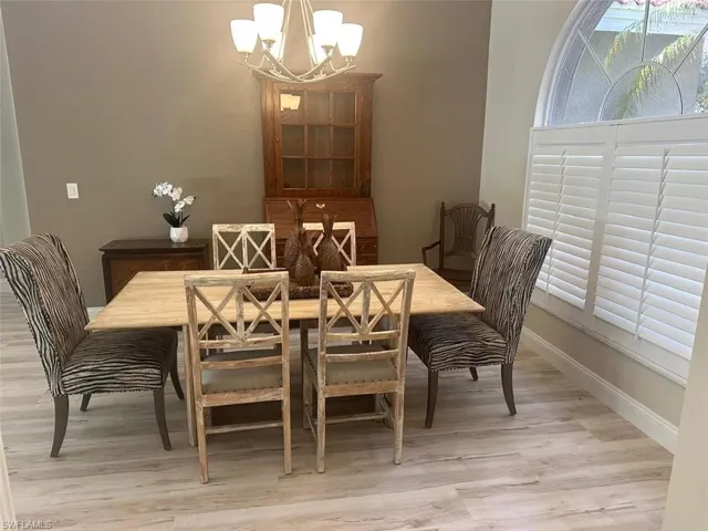 Dining space featuring light wood-style flooring and a chandelier