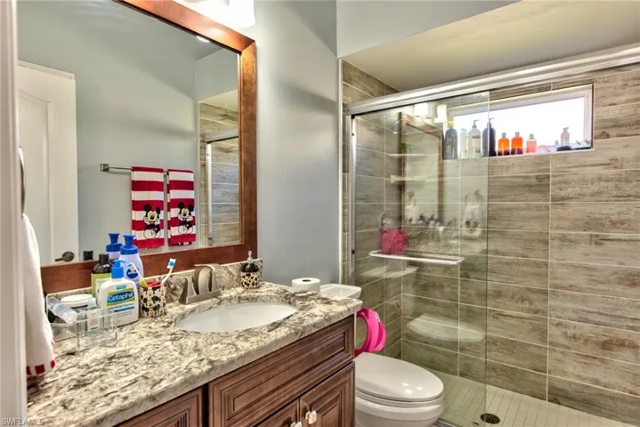 Bathroom with vanity and a shower stall