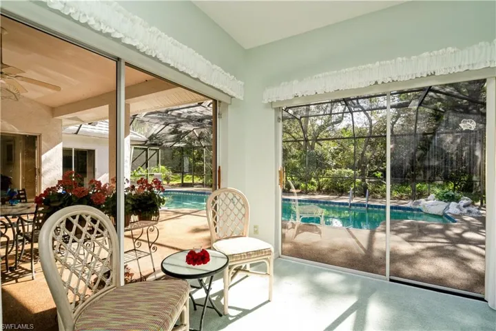 Primary bedroom featuring ceiling fan and a swimming pool
