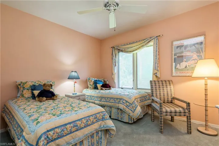 Carpeted bedroom featuring ceiling fan