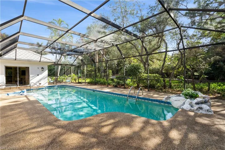 View of pool featuring a lanai and a patio area