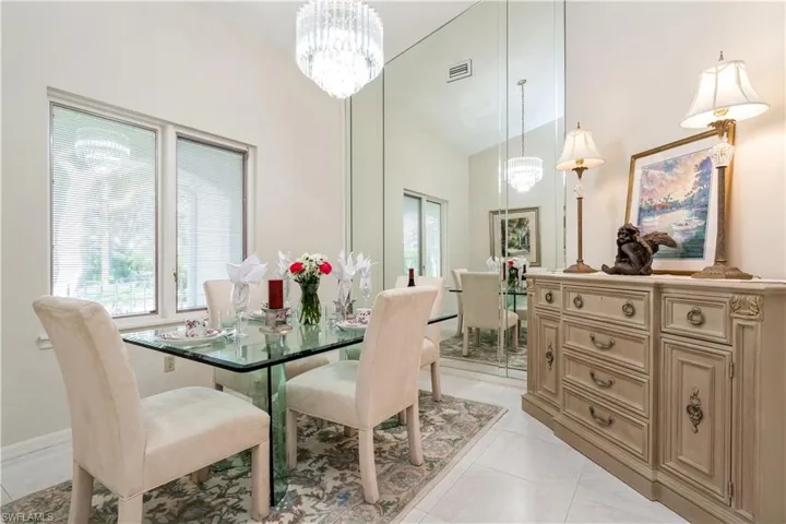 Tiled dining area with an inviting chandelier