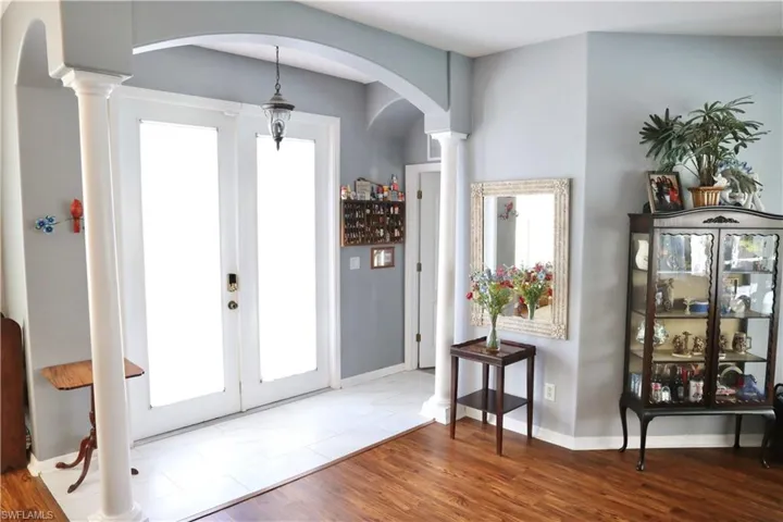Foyer entrance featuring french doors, and ornate columns