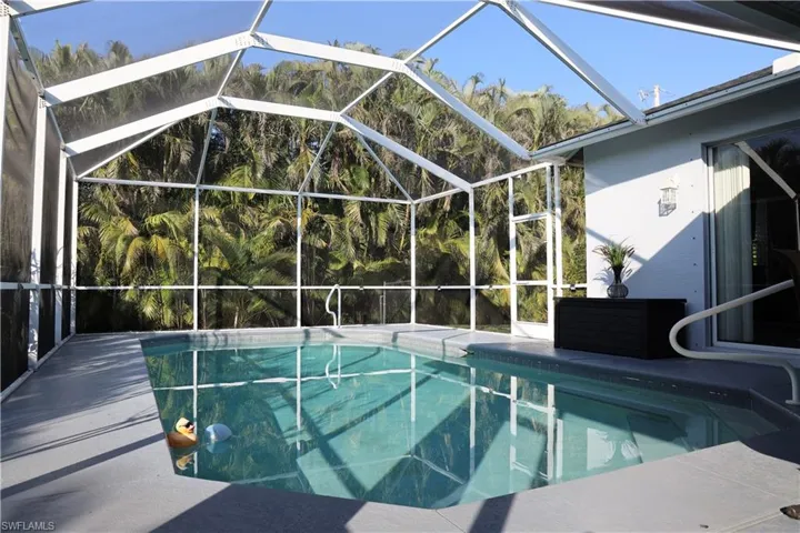 View of swimming pool with a lanai