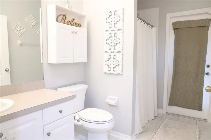 Pool Bathroom, shower, vanity and toilet
