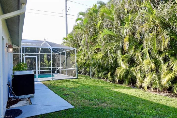 View of backyard, pool heater, & pool lanai area
