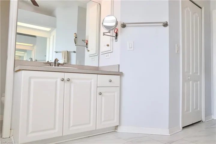 En-Suite Bathroom featuring vanity & walk-in closet