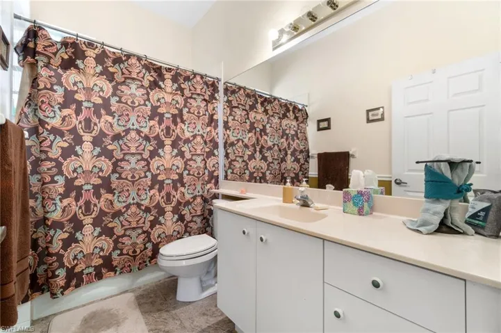 Bathroom with tile patterned flooring, toilet, and vanity