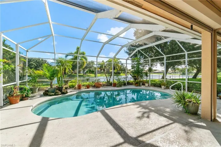 View of swimming pool featuring a patio and a lanai