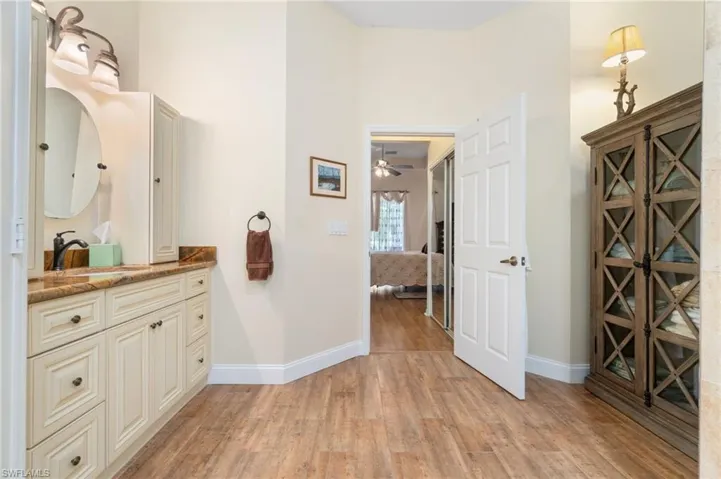 Bathroom featuring vanity, ceiling fan, and hardwood / wood-style floors