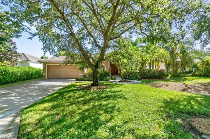 View of front of house featuring a garage and a front yard
