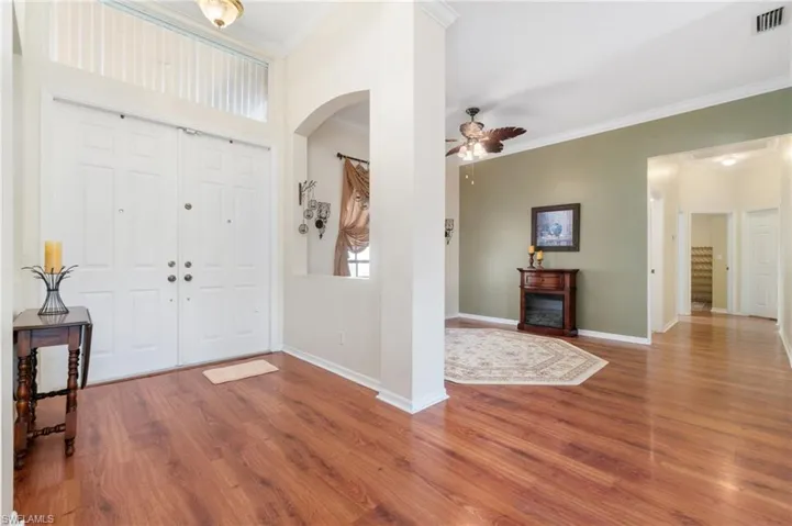 Foyer featuring ornamental molding, ceiling fan, and hardwood / wood-style floors