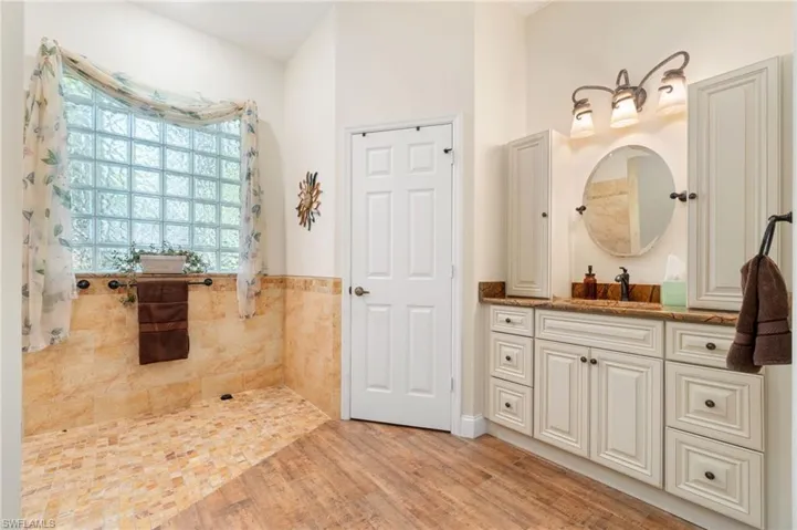 Bathroom with hardwood / wood-style floors and vanity
