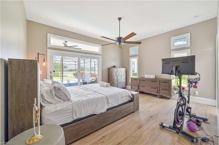 Bedroom featuring ceiling fan, light hardwood / wood-style flooring, and access to exterior
