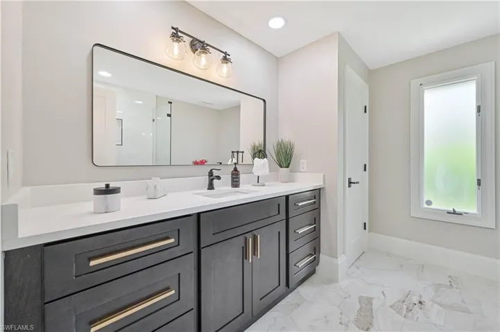 Bathroom featuring tile patterned flooring and vanity