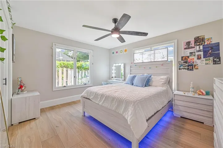 Bedroom featuring ceiling fan and light hardwood / wood-style flooring