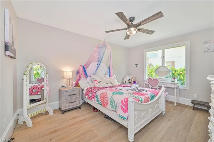 Bedroom with ceiling fan and light hardwood / wood-style floors