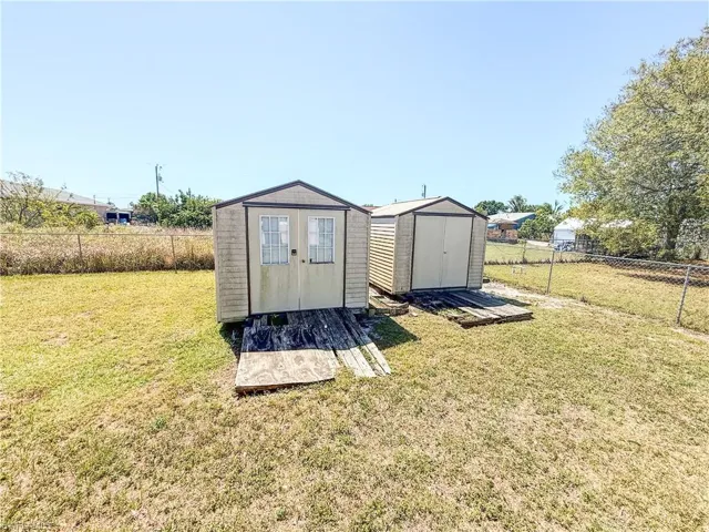 View of shed with a fenced backyard
