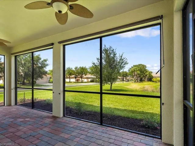 Screened lanai with ceiling fan and brick pavers