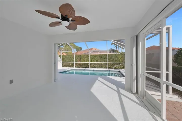 View of swimming pool featuring ceiling fan