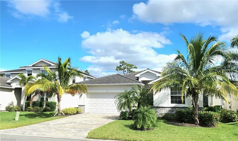 View of front of property featuring a garage and a front yard
