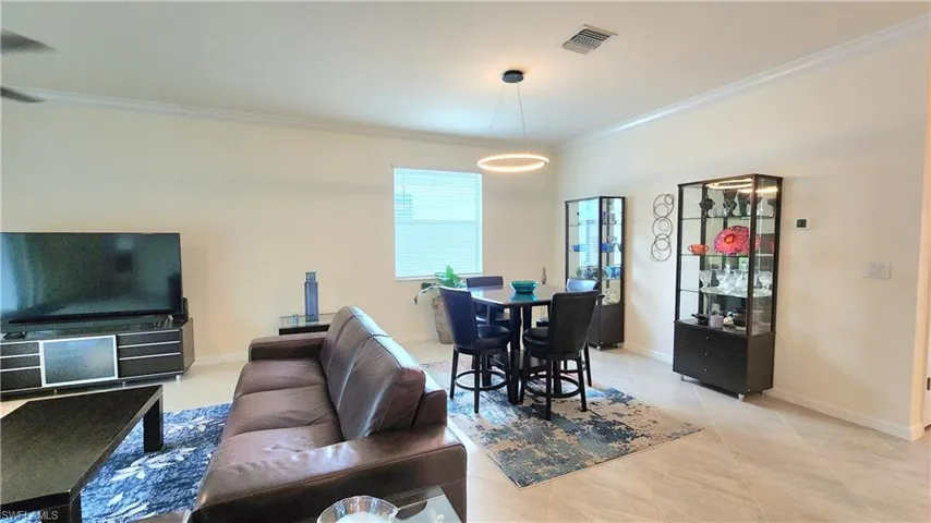 Tiled living room featuring ornamental molding