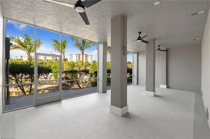 View of patio / terrace with ceiling fan and a sunroom
