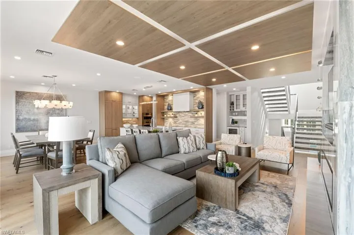 Living room featuring stairway, wood ceiling, light wood-type flooring, and recessed lighting